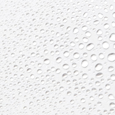 Close-up image of droplets from Antu Radiance Mist on a white background.